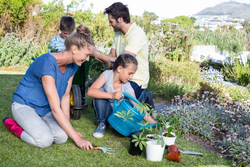 Trained landscapers handling garden debris on a Balham property